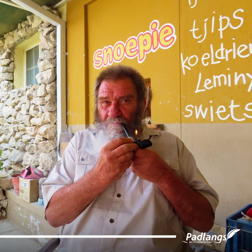 Basil Calitz, owner of the Brandberg Rest Camp, lighting his pipe